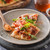 Slices of flatbread pizza topped with melted cheese, diced tomatoes, arugula, and Hot Honey Seasoning.