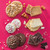 Assorted baked treats including cookies, frosted cookies, cake slices, and brownies on a pink background.