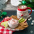 Bowl of Cherry Soda dip served with apple slices and graham crackers beside a Santa mug of hot cocoa.