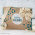 Tastefully Simple gift box with a "Happy Holidays" gift tag and decorative ribbon.