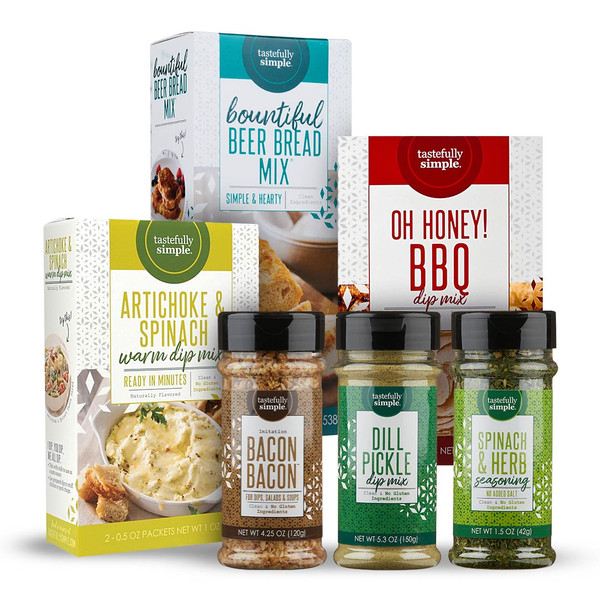Assortment of Tastefully Simple products including Bountiful Beer Bread Mix, Artichoke & Spinach Warm Dip Mix, Oh Honey! BBQ Dip Mix, Bacon Bacon™ Seasoning, Dill Pickle Dip Mix, and Spinach & Herb Seasoning.