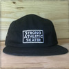This is our super durable Strong Athletic Skater 5-Panel Cap. The cap is in the color black, with white embroidery and a light blue bill. This hat has an adjustable brown strap that is made from vegan leather. The Strong Athletic logo is embroidered no the back of each hat. 