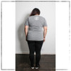 This is the back of the Strong Athletic Woman t-shirt. The white logo is at the top of the shirt. The color is athletic grey, it matches pretty much everything. This shirt is made by Strong Athletic the feminist woman owned LGBT company that supports all athletes in sports. Strong Athletic made the Strong Athletic Woman design because we wanted to amplify the voices of female athletes who were asking to be treated with respect and equality in sports. The fabric is an athletic grey with the words printed in white ink. 
