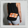 This is the Strong Skater Fanny Pack made by Strong Athletic in collaboration with Flat Track Revolutions. This bum bag is neon orange with shiny silver ink. This small bag comes with a zipper and an adjustable strap and is perfect to wear while roller skating. #strongathletic , #strongathletiskater , #rollerderby , #rollerderbyskater , #rollerderbyathlete 