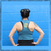 This is the back of the Strong Athletic Queer Deep Heather Teal with Yellow Ink Crop Racerback Tank Top by Strong Athletic. The back of this tank is slightly flowy, which gives it a really cool look as if you cut up an old shirt.  