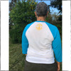 This is the back of the Strong Athletic Woman 3/4 sleeve shirt. The sleeves are an aqua blue, the body of the shirt is white. The words Strong Athletic Woman are printed in bright yellow ink across the front. Both sides of the shirt feature our logo. Looking for the perfect baseball shirt as a gift for a friend or yourself, this one is our favorite. 