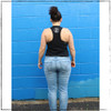 This is the side view of the Strong Athletic Grown-Ass Woman Crop Top Racerback Tank Top in Black with White Ink by Strong Athletic.  Are you looking for crop tees that end above the waste line? People love this crop tank because it’s preshrunk and and super soft. We print this design on the Bella Canvas 6682 Crop Top Racerback Tank. All Bella shirts are made at a W.A.R.P. Certified facility. 
