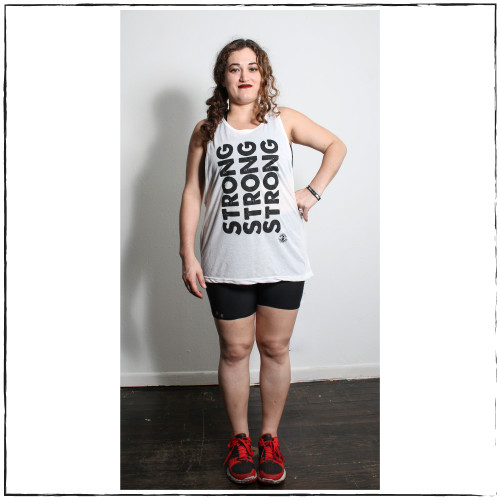 Sold Out! The Drop Arm White Muscle Tank with Black Ink with the words  Strong Written Vertically in Black Ink