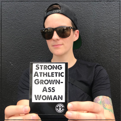 You are a Strong Athletic Grown-Ass Woman. Tell people. Be proud. Explain what it means to you. Ask people why they agree with this statement.  Ask people why they disagree with this statement. This shiny black sticker with white ink says it all. It says it boldly, while leaving room for conversation.