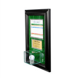 side view of a hole in one ball and scorecard display with a golf ball over green backing in a black frame