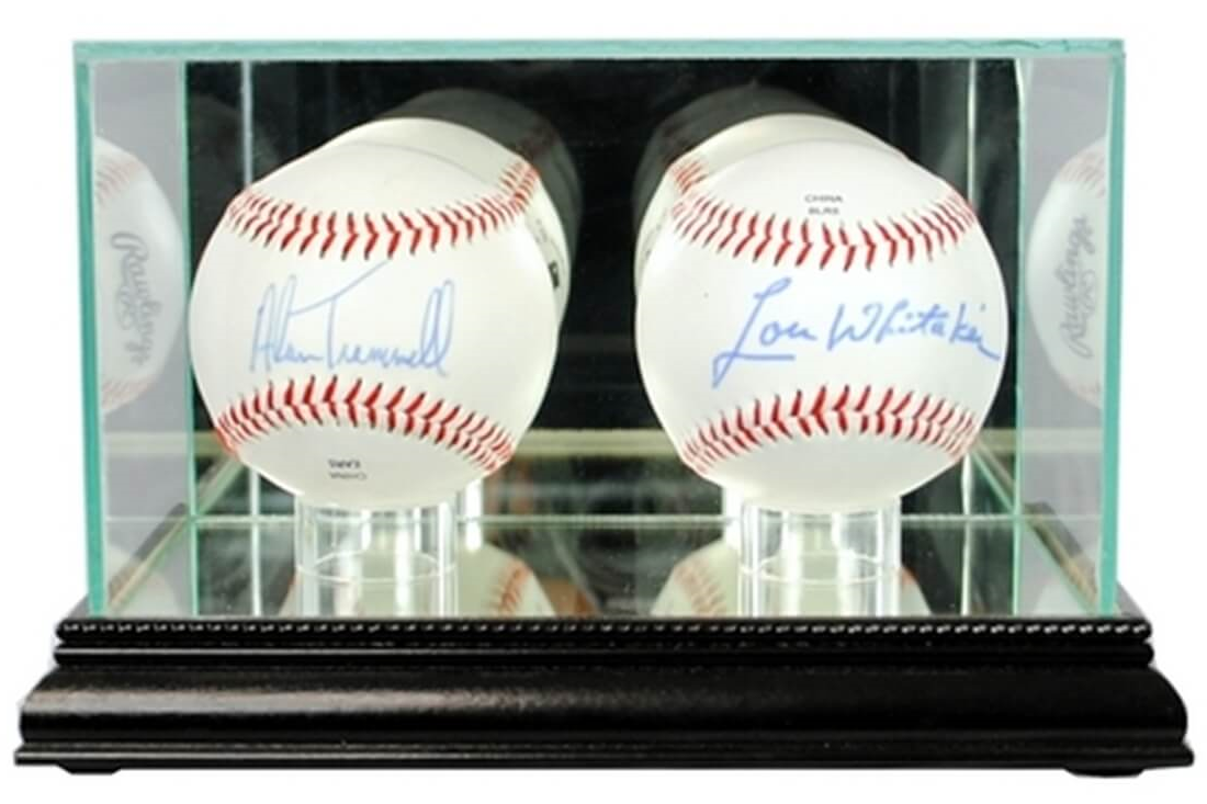 Two baseballs inside a glass display case