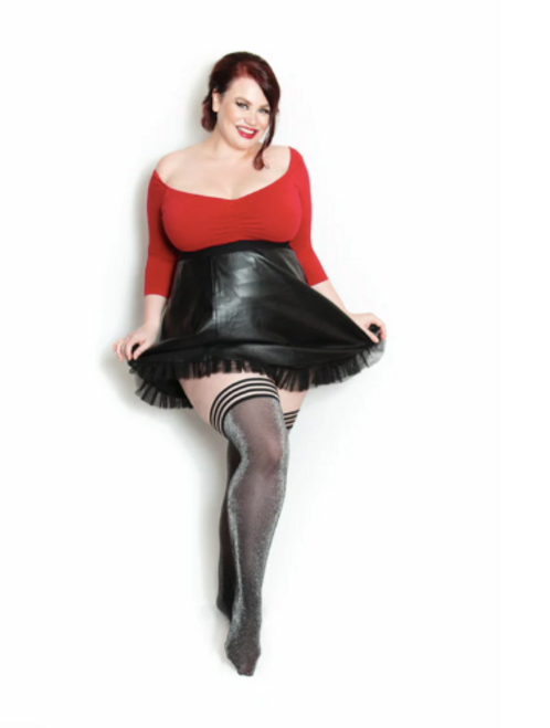 Plus size female model wearing black wet look mini skirt and Kix'ies black and silver lurex thigh high stockings. Plus size female model wearing black wet look mini skirt and Kix'ies black and silver lurex thigh high stockings.