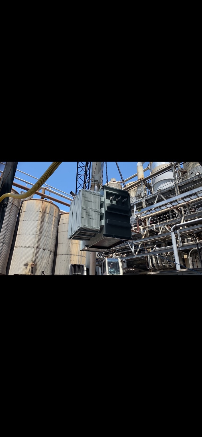 Transformer being lifted in an industrial facility