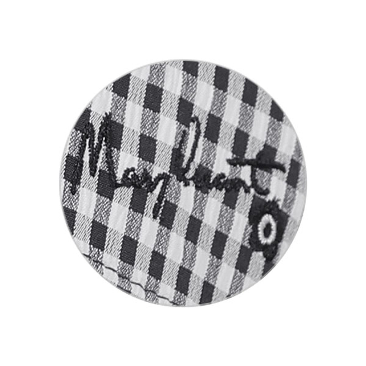 A close up of the embroidery on the black gingham cap. Mary's signature and the Mary Quant daisy is embroidered in black.