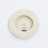 The inside of the white beret showing the Mary Quant logo and daisy printed inside.