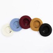 This image shows all 5 colourways of Mary Quant Classic Beret: black, burgundy, mustard, blue and white. They are placed showing the inside of the beret, displaying the Mary Quant brand logo.