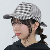 A model wears the black and white gingham cap.
