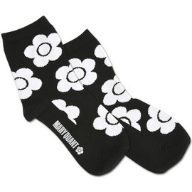 Black socks with white daisies on them. The socks also have the Mary Quant logo printed on the side of the foot.