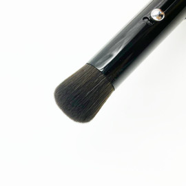 Powder Compact Brush is pictured, it is a has a black handle withh the Mary Quant Daisy printed on it in white. The brush bristles are black and are made of synthetic fibre. Powder Compact Brush is pictured, it is a has a black handle withh the Mary Quant Daisy printed on it in white. The brush bristles are black and are made of synthetic fibre.