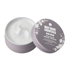 A grey cylindrical tin of hand cream, open to show the white hand cream inside. The lid of the tin has Mary Quant Essentials Hand Cream and the Mary Quant Daisy printed on the front in white. This scent is Special Recipes. A grey cylindrical tin of hand cream, open to show the white hand cream inside. The lid of the tin has Mary Quant Essentials Hand Cream and the Mary Quant Daisy printed on the front in white. This scent is Special Recipes.