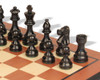 Chess set featuring French Lardy Staunton design on molded-edge mahogany and maple board Black pieces Close up