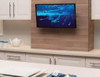 Sanus VTVS4-B2 tilt mount with 32-inch TV adjusted for glare-free couch viewing in living room