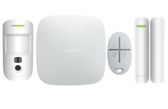 White Ajax Hub 2 Plus Starter Kit unboxing showing Hub 2 Plus, Motion Cam PIR, Door Protect reed switch, and Space key fob for wireless security