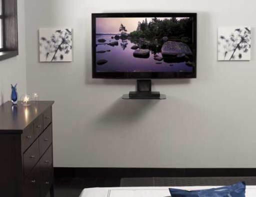 Sanus VMA401 under TV wall shelf adjusted below 55-inch mounted TV holding soundbar neatly