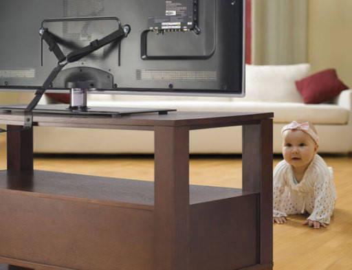 Sanus ELM701 anti-tip strap anchored between 65-inch TV and wall preventing tip-over for family safety