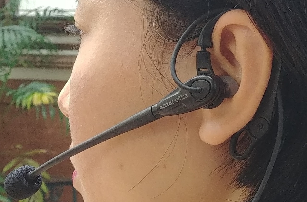 Model wearing the eartec 200 in-the-ear headset