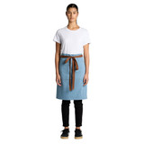 A denim half apron in light blue with a brown waist tie, displayed on a model wearing a white T-shirt and black pants.