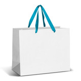 A large paper bag in white with teal ribbon handles, featuring a blank surface and no visible branding.
