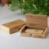 A bamboo phone case displayed in an open and closed position, featuring a simple design and natural wood finish.