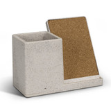 A speckled grey wireless charger desk caddy with a cork backing and compartment for holding small items.
