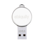 A mini round crystal flash drive in silver and clear, featuring a branding logo on its surface.