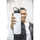 A drink bottle in white with a black lid and a built-in straw, held by a person. It has a logo on it.