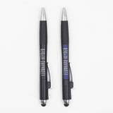 A pair of black pens with silver accents and branding, featuring rubber grips and stylus ends.