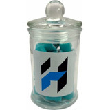 A glass apothecary jar filled with blue rock candy, featuring a logo on the front.