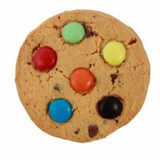 A round cookie with a golden-brown base topped with colourful chocolate buttons in green, yellow, orange, blue, and black.