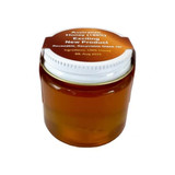 A glass jar of amber honey, featuring a lid and a label indicating it’s 100% Australian honey.