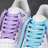 Double-layer shoe laces in lavender and light blue, featured on white sneakers with textured soles.