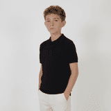 A youth's black polo shirt with a collar and buttons, featuring short sleeves. It has a logo on it.