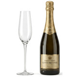 A bottle of champagne with a gold label beside a clear glass flute. The items are set against a plain background.