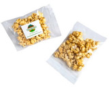Caramel popcorn in a clear branded bag, featuring light brown and golden popcorn clusters.