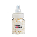 A baby bottle filled with white mints, featuring a clear body and a white lid, with branding on the front.