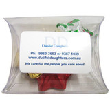 A pillow pack containing assorted chocolate stars in red, green, and gold foil. The pack includes branding.
