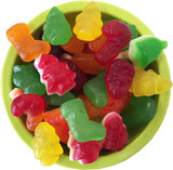 A green bowl filled with colourful mixed lollies shaped like Christmas trees, stockings, and Santa, in orange, red, yellow, and green.