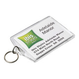 A clear hotel keychain featuring a logo and details for Ibis Styles Adelaide Manor, attached to a metal ring.