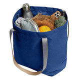 A navy blue tote bag filled with a drink bottle, food items, and a grey pouch, featuring sturdy handles.