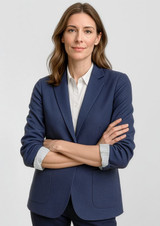 A navy blue women's blazer with a tailored fit and a branding logo. The model has arms crossed, displaying the jacket.